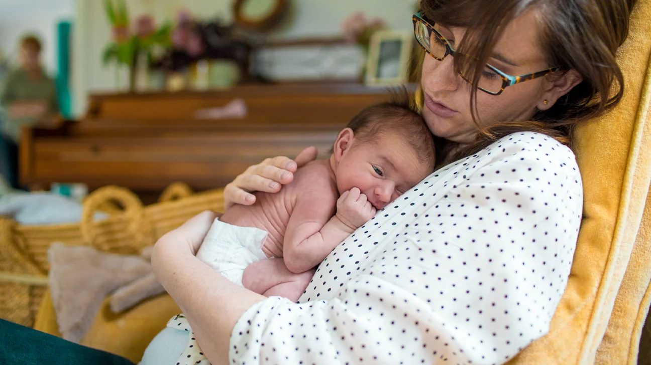 Mother-holding-newborn-baby-in-nursery-1296x728-header